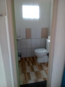 a small bathroom with a toilet and a window at Izaac's Bed & Breakfast in Lovina +37 photos