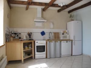 a kitchen with white appliances and a white refrigerator at Dans l'Air du Temps in Flagey