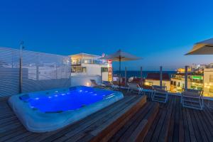 a hot tub sitting on the deck of a building at Hotel Baltum in Albufeira