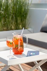 a drink and a wine glass on a table at Hotel Baltum in Albufeira