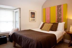 a bedroom with a large bed and a window at 7 Boutique Hotel in Galway