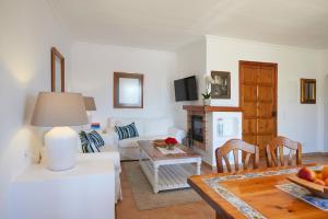 a living room with a couch and a table at Las Escaleras - Villa SIKA - 4S in Port d'Andratx