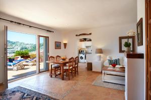 a kitchen and living room with a table and chairs at Las Escaleras - Villa SIKA - 4S in Port d'Andratx