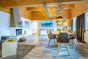 a kitchen and dining room with a table and chairs at Active Apartments in Maria Alm am Steinernen Meer