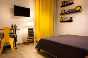 a bedroom with a bed and a yellow curtain at Napoli Boulevard B&B in Naples