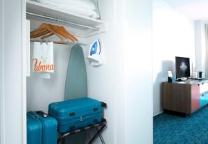 a room with two pieces of luggage sitting on a stool at Universal's Cabana Bay Beach Resort in Orlando