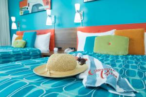 a straw hat and towels on a bed at Universal's Cabana Bay Beach Resort in Orlando