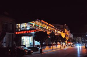 a building on the side of a street at night at Rooms Turist in Vladičin Han