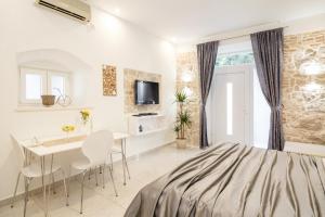 a bedroom with a bed and a table and chairs at Apartment Maleš in Split