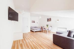 a living room with a couch and a table at Apart Hotel Rishelye in Odesa