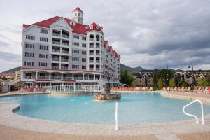 a large building with a water fountain in front of it at RiverWalk Resort at Loon Mountain in Lincoln
