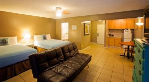 a hotel room with two beds and a couch at Ocean Villa Inn in San Diego