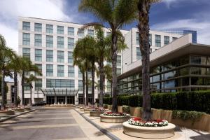 a building with palm trees in front of it at Four Seasons Hotel Silicon Valley at East Palo Alto in Palo Alto
