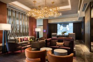 a lobby with couches and chairs and a chandelier at Four Seasons Hotel Silicon Valley at East Palo Alto in Palo Alto