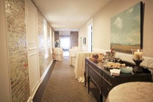 a hallway with a room with tables and a room with two tables at Hotel Laurance in Luray