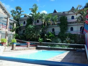 a swimming pool in front of a building at Otellin Triumph Hotel in Triunfo