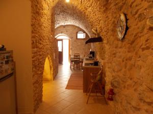 a kitchen and dining room with a stone wall at Traditional Guest house Chrisyis in Pyrgi