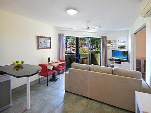 uma sala de estar com um sofá e uma mesa em Noosa River Sandy Shores em Noosaville