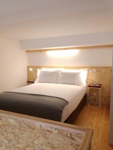 a bedroom with a large bed with white pillows at DL 205 in Porto