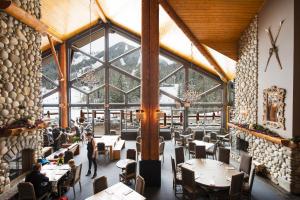 
a restaurant with tables and chairs in it at Lizard Creek Lodge in Fernie
