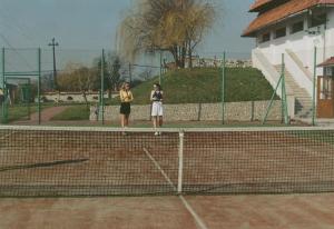 two women are standing on a tennis court at Zajazd Kosynier in Węgrzce