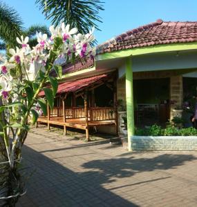 a building with a bench in front of it at Cerah Hotel in Paiton