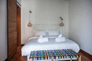 a bedroom with a white bed with towels on it at Lemon Tree Stay in Faro