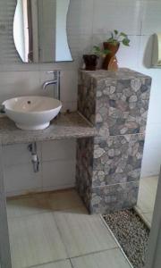 a bathroom with a sink and a mirror at Cerah Hotel in Paiton