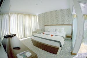 Ένα ή περισσότερα κρεβάτια σε δωμάτιο στο Idahan Hotel
