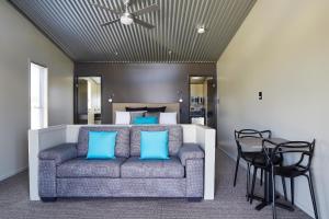 a living room with a couch in front of a bed at Ridgemill Estate in Stanthorpe