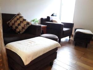 a living room with a couch and two chairs at Bluesky Serviced Apartment Airport Plaza in Ho Chi Minh City