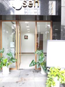 a store front with potted plants in front of it at Bluesky Serviced Apartment Airport Plaza in Ho Chi Minh City