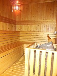 an empty wooden sauna with a tub in it at Bluesky Serviced Apartment Airport Plaza in Ho Chi Minh City