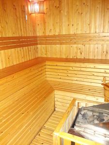 a large wooden sauna with a wooden tub in it at Bluesky Serviced Apartment Airport Plaza in Ho Chi Minh City