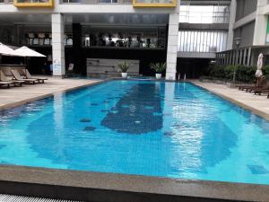 a large blue swimming pool in a building at Bluesky Serviced Apartment Airport Plaza in Ho Chi Minh City