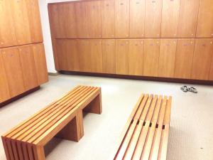 a pair of wooden benches in a locker room at Bluesky Serviced Apartment Airport Plaza in Ho Chi Minh City
