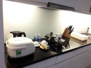 a kitchen counter with a toaster and pots and pans at Bluesky Serviced Apartment Airport Plaza in Ho Chi Minh City