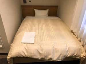 מיטה או מיטות בחדר ב-Hotel Crown Hills Iwaki