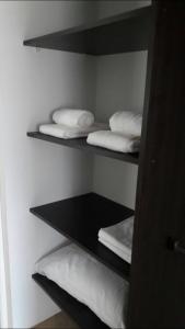 a room with three shelves with white towels at Apartamento Lo de Ana in Termas de Río Hondo