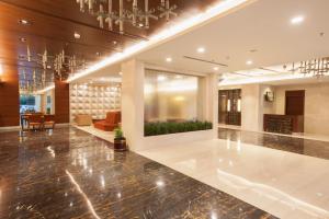 a lobby of a hotel with a chandelier at Dolphin Hotel in Visakhapatnam
