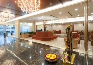 a lobby with a waiting room with a couch and a table at Dolphin Hotel in Visakhapatnam