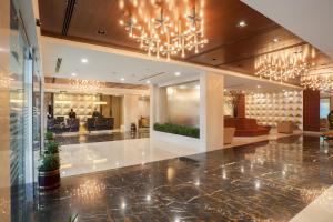 a lobby of a hotel with a chandelier at Dolphin Hotel in Visakhapatnam