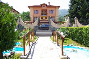 a villa with a staircase leading to a house at Complex Diana in Cherven