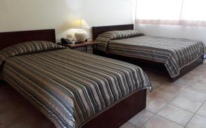 Postel nebo postele na pokoji v ubytování Citystate Asturias Hotel Palawan