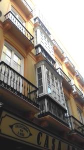 un edificio con balcones y un letrero para una cafetería en Del Parque Flats Santos Exclusive, en Málaga