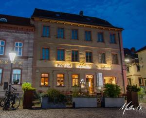 a building with a bike parked in front of it at Müller! Das Weingut & Weinhotel in Hammelburg