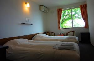Postel nebo postele na pokoji v ubytování Hakodate Motomachi Hotel
