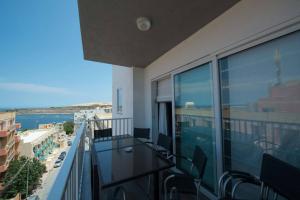 an apartment balcony with a view of the ocean at Four Seasons Apartment 9 in St. Paul's Bay