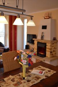 a living room with a vase of flowers on a table at Haus Bucheneck in Graal-Müritz