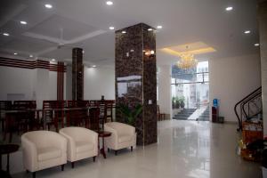 a restaurant with white chairs and a table and a mirror at Laverder Resort in Phú Quốc +79 photos